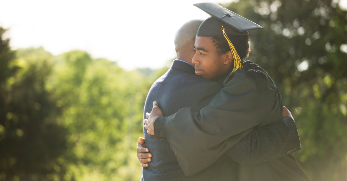 Father hugging his son on his graduation day.