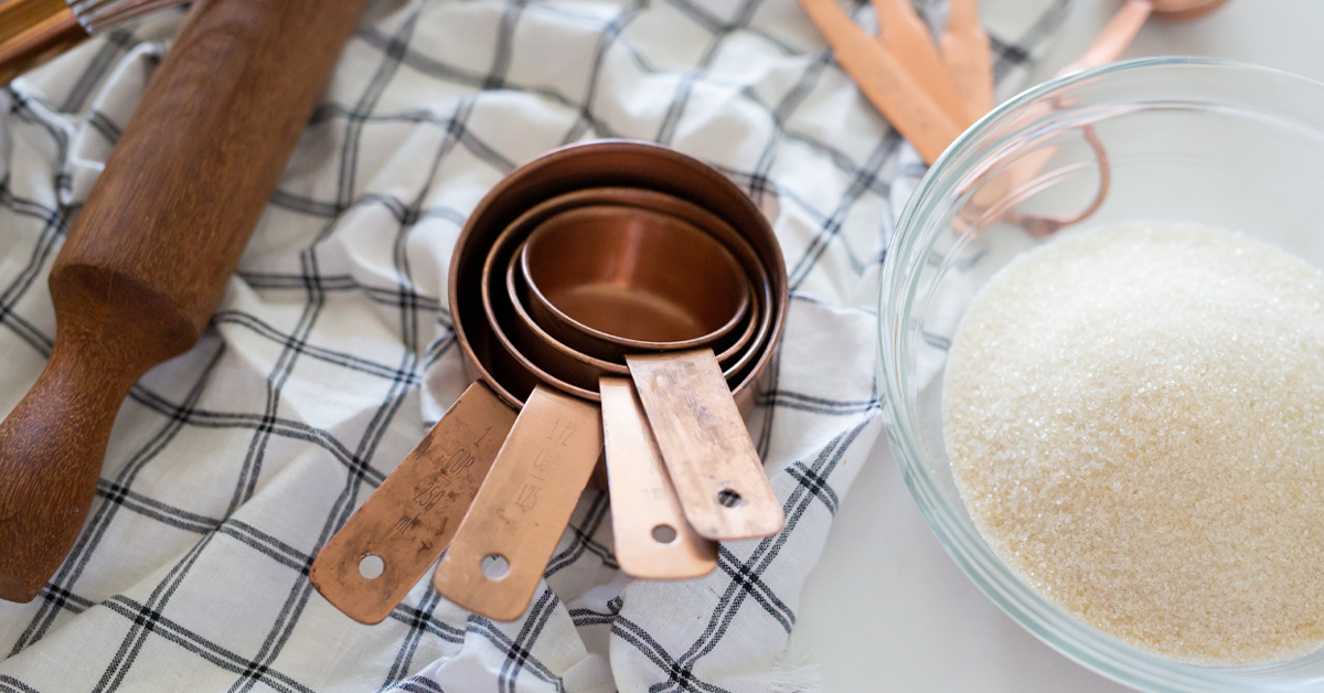 Measuring cups next to other cooking supplies.